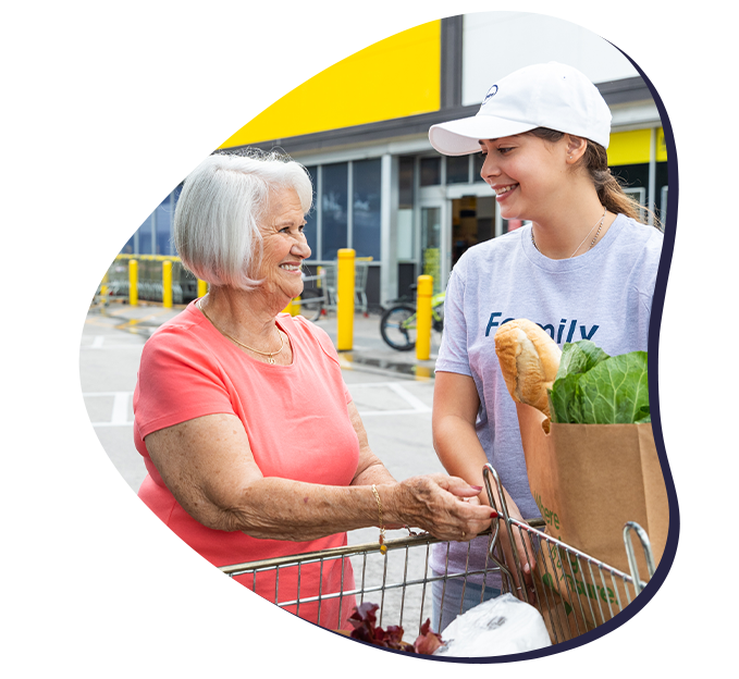 Papa Pal helping a member with groceries